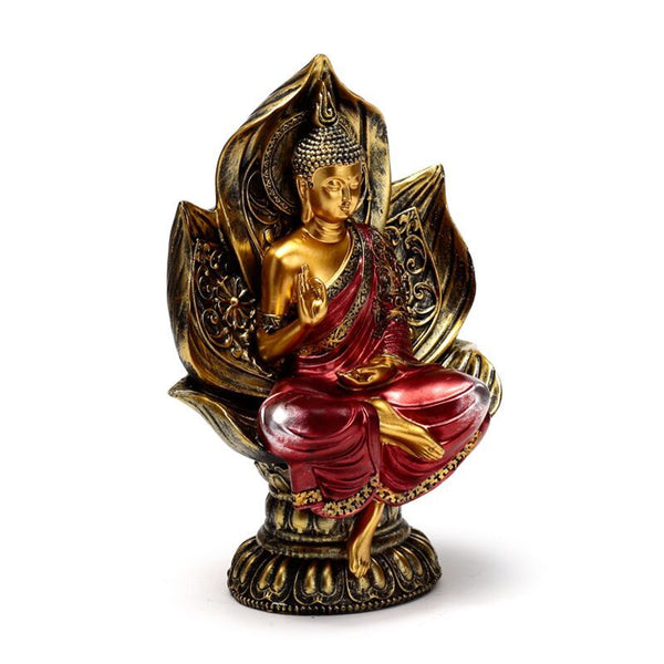 Decorative statue of a seated figure in red and gold on a white background